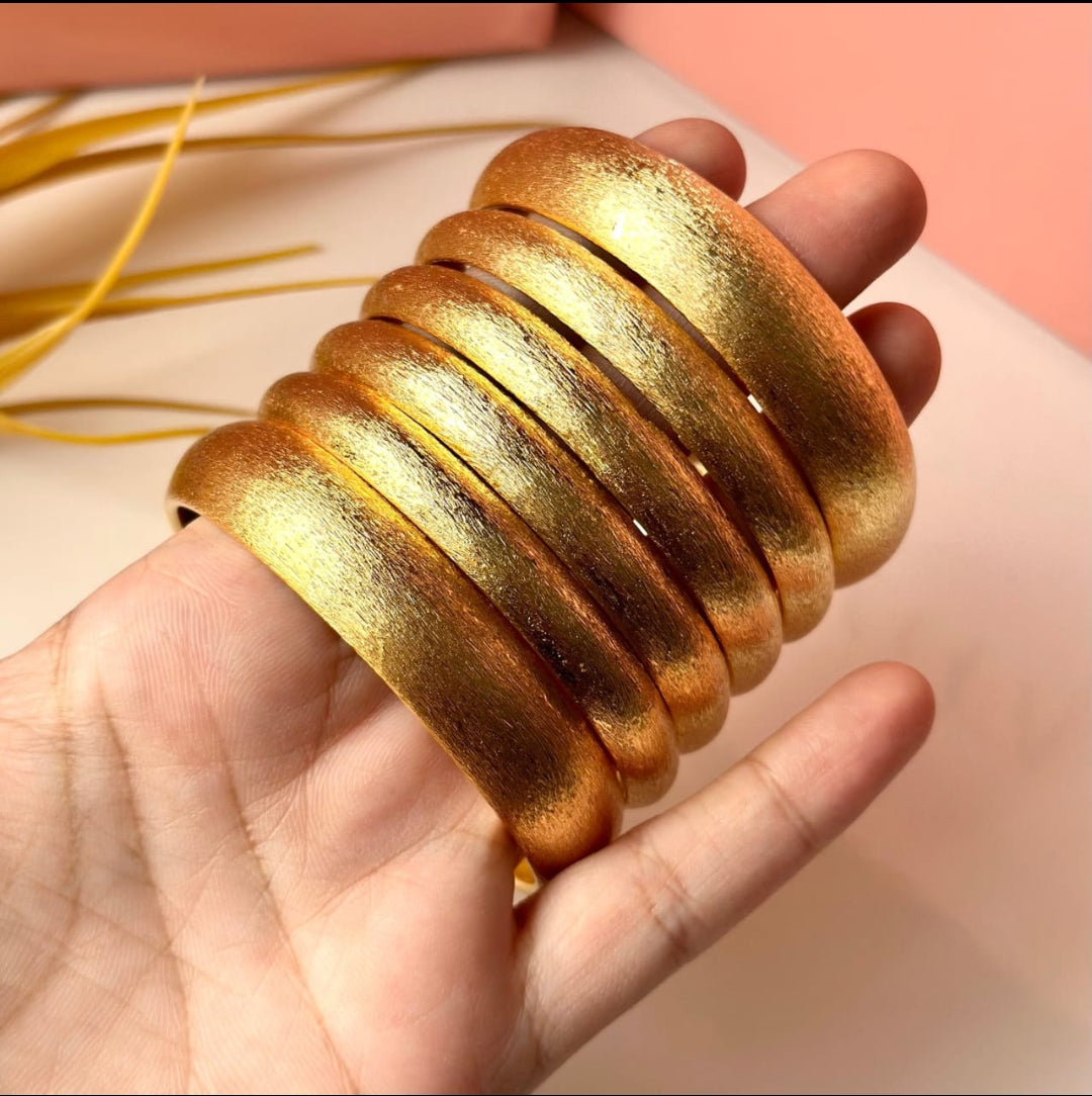 6 exquisite thick golden bangles.