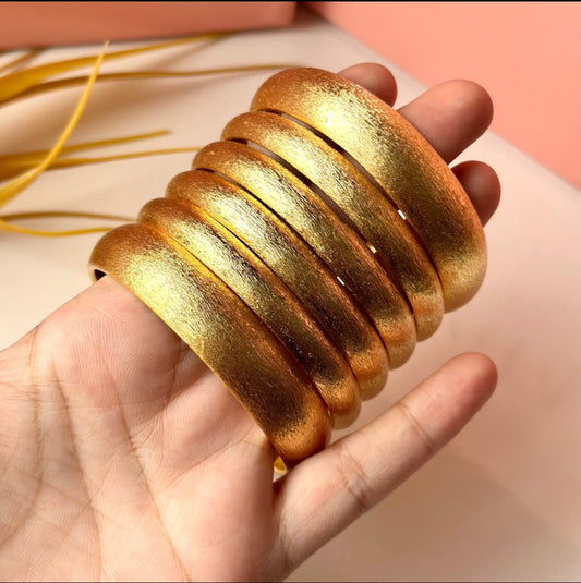 6 exquisite thick golden bangles.