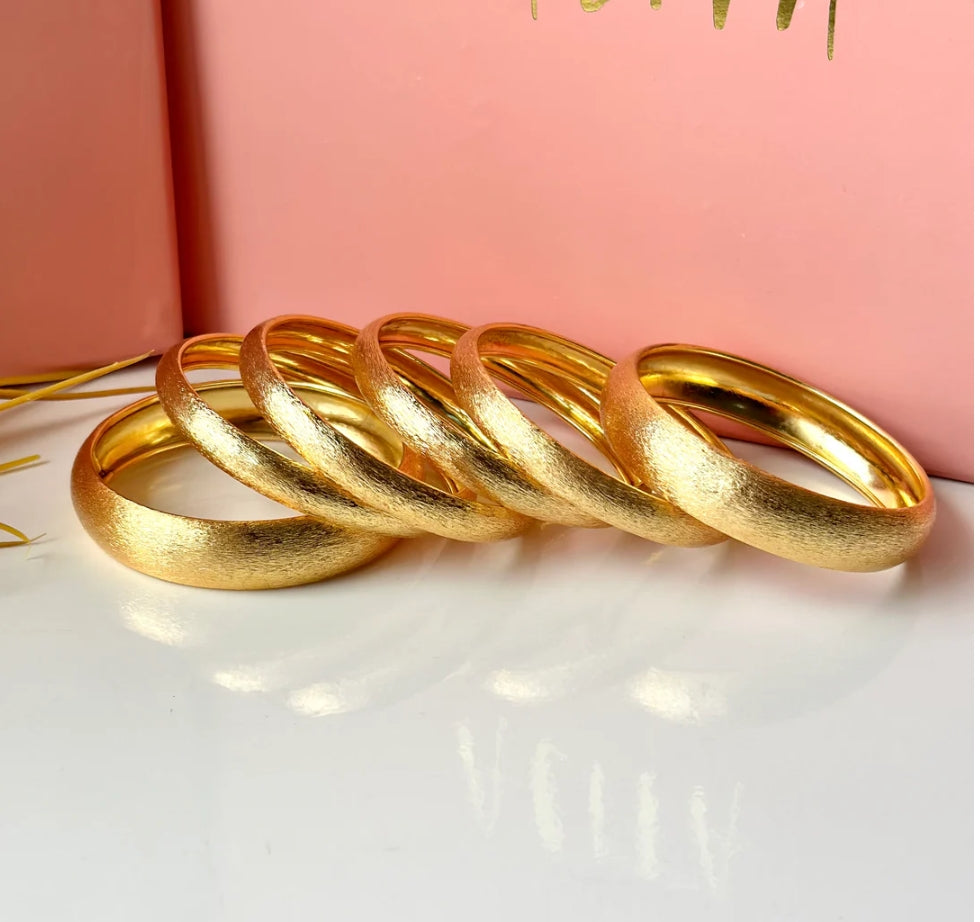 6 exquisite thick golden bangles.